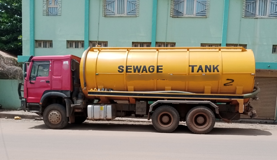  a yellow sewage truck