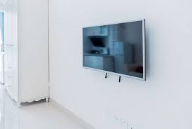  A TV screen hanging on a white interior wall in Juba, South Sudan