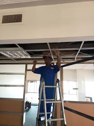 A techician installing drop ceilings in Juba, South Sudan