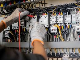 An electrician's hand working on a power panel in Juba South Sudan