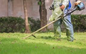 grass-cutting machine beig used by a man in Juba, South Sudan