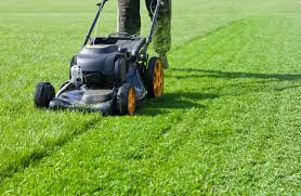 A man using a lown mower in Juba, South Sudan