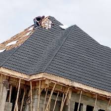  A techician fixing iron sheet roofs in Juba, South Sudan 