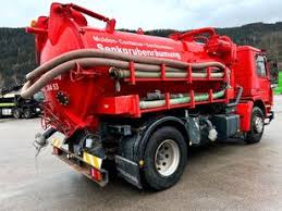 The back and side view of a red sewage truck in Juba, South Sudan